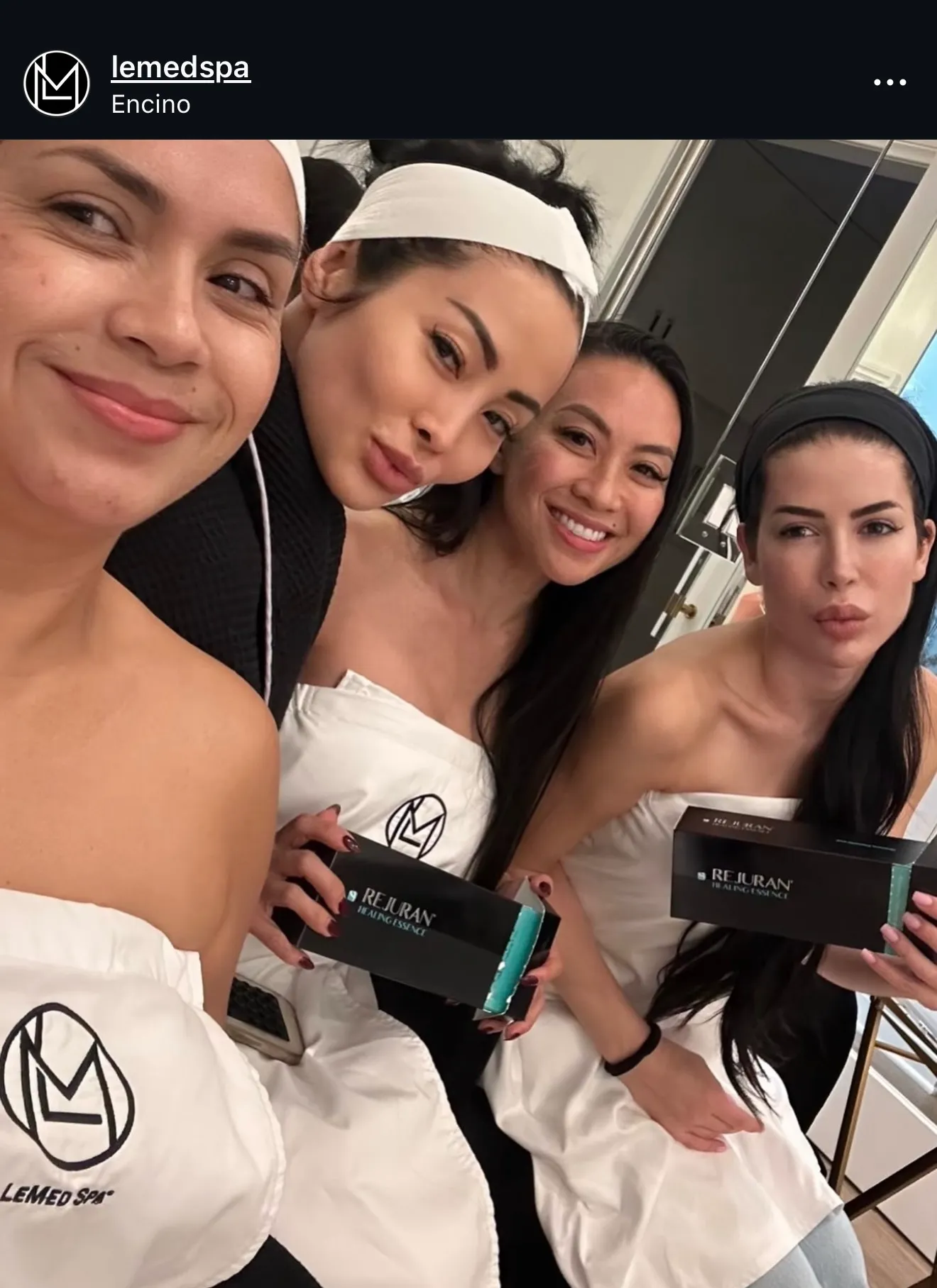 LeMed Spa team members in white robes with Rejuran skincare products